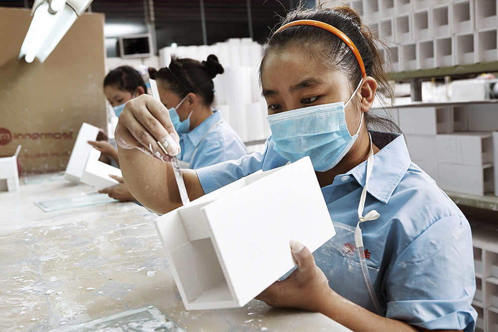 A worker carefully repairs this plaster product.